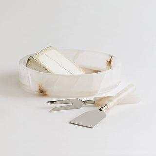Santo Alabaster Cheese Tools Set with a flat knife and fork, stylishly complementing soft cheese on a decorative bowl.
