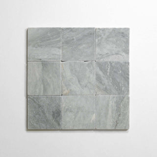 Bardiglio 4x4 tumbled marble tile, featuring a sleek gray finish, ideal for flooring and wall decoration.