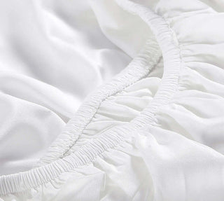 Close-up of natural premium bamboo fitted sheet, showcasing smooth, silky texture and elastic edges for a secure fit.
