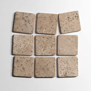 Chocolat 4x4 inch tumbled marble tile, showcasing a group of beige, textured tiles perfect for home decor.