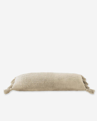 Braided pom pom lumbar pillow with memory foam and removable cover in soft beige tone.