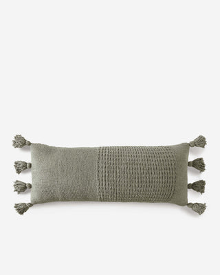 Braided pom pom lumbar pillow in olive green, featuring a memory foam core and textured cover.