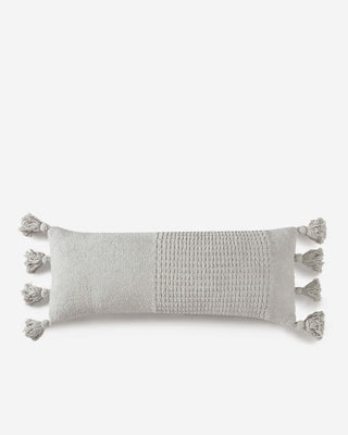 Braided pom pom lumbar pillow in soft gray with decorative tassels and memory foam filling, OEKO-TEX® certified.