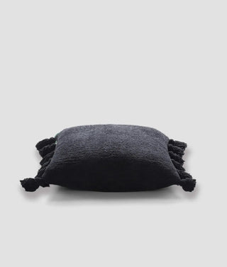 Soft black pom pom throw pillow with fuzzy edges, crafted from memory foam and microfiber, OEKO-TEX® certified.