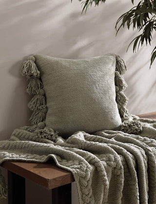 Soft green pom pom throw pillow with textured microfiber, perfect for cozy decor and OEKO-TEX® certified.