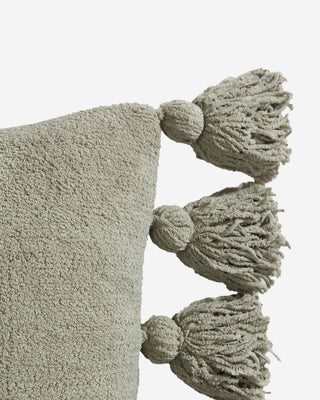 Soft microfiber Pom Pom Throw Pillow in muted green with fuzzy pom pom balls on the edges.