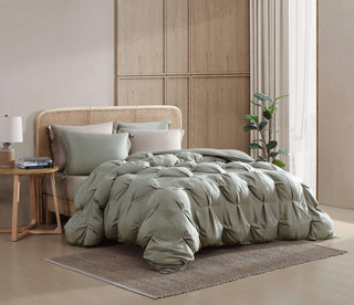Premium Bamboo Bubble Comforter Bundle in sage green on a bed with matching shams, enhancing a cozy bedroom aesthetic.