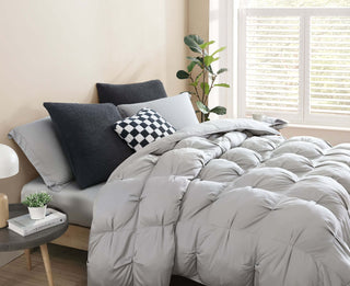 Premium Bamboo Bubble Comforter Bundle on a bed with stylish pillows and fresh plant decor.