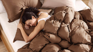 Woman peacefully sleeping under a brown Premium Bamboo Bubble Comforter on a cozy bed.