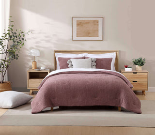 Cozy bedroom featuring a Pom Pom Throw Pillow on a stylish bed, complemented by soft decor and a calming color palette.