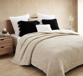 Cozy bedroom setup featuring Pom Pom Throw Pillow on bed with soft blanket and stylish decor.