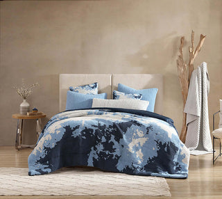 Double Snug Pixel Comforter in blue tones on a bed, featuring cozy pillows and modern bedroom decor.