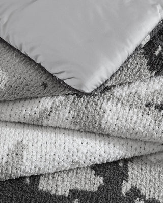 Double Snug Pixel Comforter showcasing two layers of Snug fabric with a modern multi-tone design.