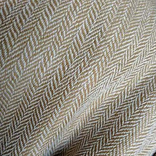 Close-up of Bina Brown Throw Blanket fabric, featuring a warm herringbone pattern, made from 100% merino wool.