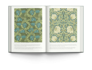 Open book displaying intricate wallpaper designs by William Morris, showcasing floral patterns and rich colors.
