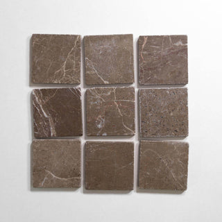 Cafe Tenayo 4x4 tumbled brown marble tiles arranged in a square pattern, showcasing natural texture and color.
