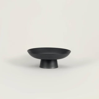 Matte black ceramic footed bowl perfect for serving fruits or decorative items, featuring a clean black finish.