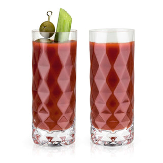 Set of 2 Gem Crystal Highball Glasses filled with a cocktail, featuring faceted design and garnished with olives and celery.