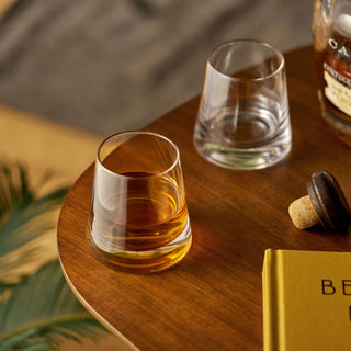 Burke Crystal Whiskey Glasses Set of 2 on a wooden table, one filled with whiskey, showcasing modern elegance and tapered design.
