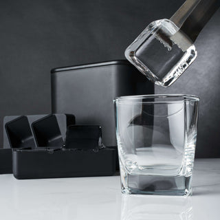 Clear ice cube being picked up for a cocktail glass, showcasing the Glacier Rocks clear ice maker.